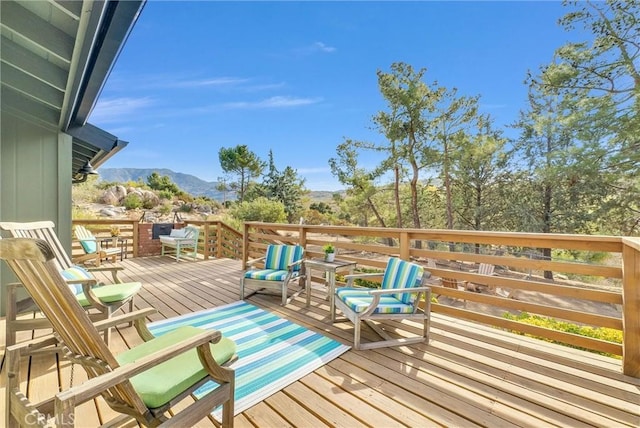 wooden deck featuring a mountain view