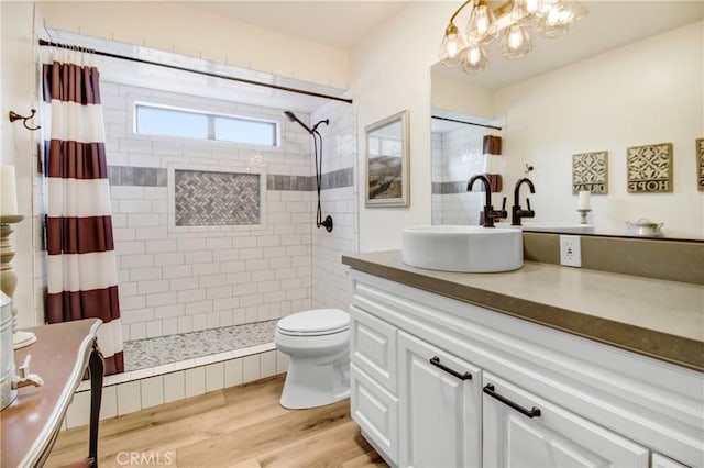 bathroom featuring curtained shower, toilet, vanity, and hardwood / wood-style flooring