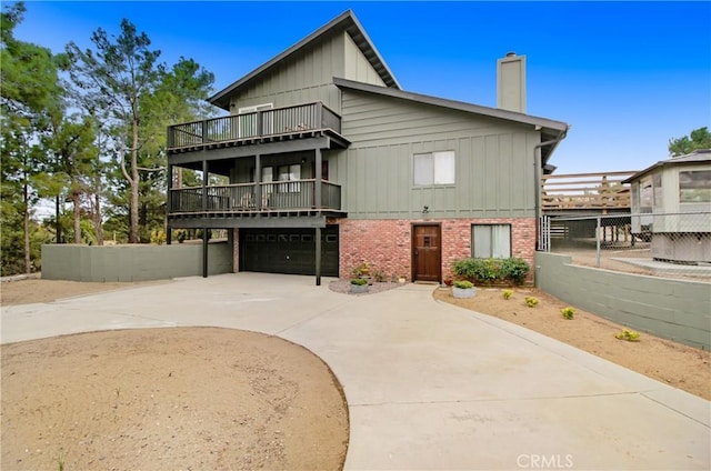 view of front of property with a balcony and a garage