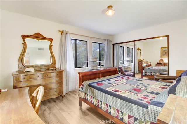 bedroom with a closet and light hardwood / wood-style flooring