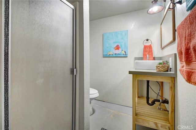 bathroom featuring toilet and an enclosed shower