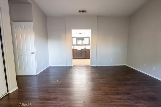 unfurnished room featuring dark hardwood / wood-style flooring