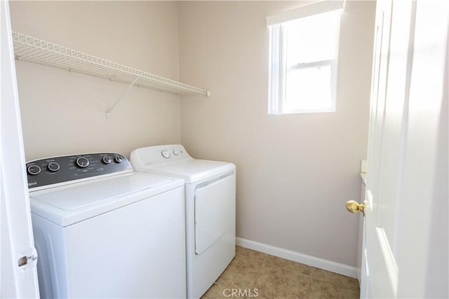 washroom featuring washer and dryer and light tile patterned floors