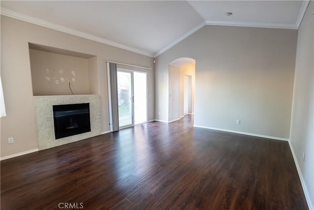 unfurnished living room with dark hardwood / wood-style flooring, lofted ceiling, ornamental molding, and a tiled fireplace