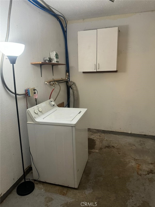 laundry area featuring a textured ceiling, laundry area, and washer / clothes dryer