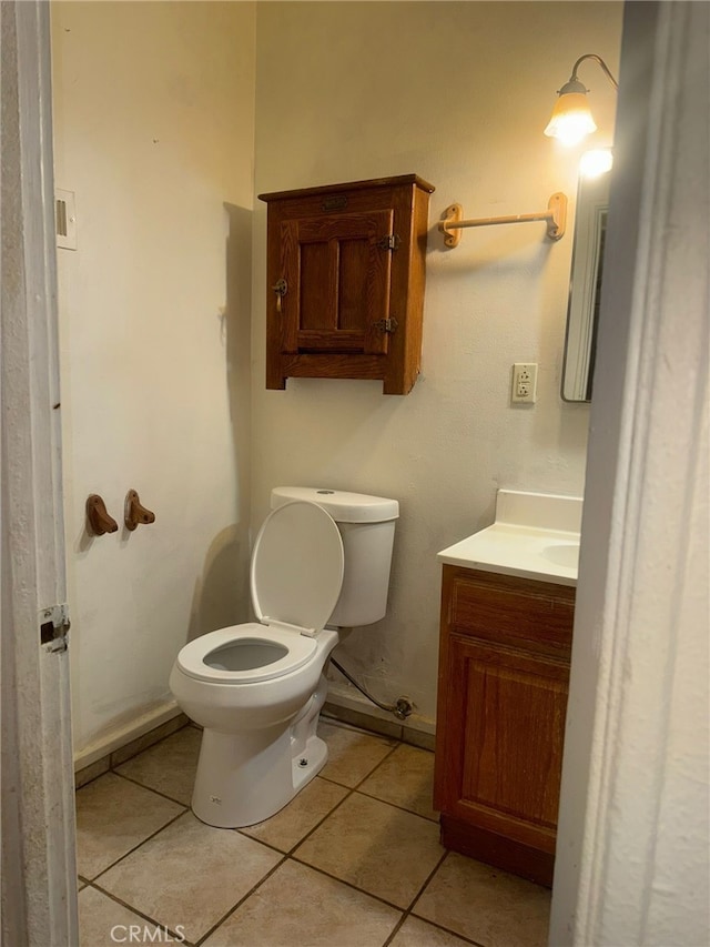 24144 Joshua Ave, Boron, CA 93516 - half bathroom with tile patterned floors, vanity, baseboards, and toilet