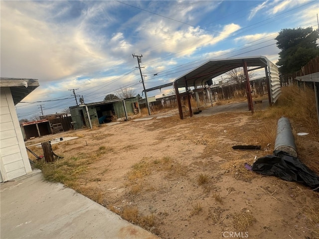 24144 Joshua Ave, Boron, CA 93516 - view of yard featuring a detached carport, fence, and an outdoor structure
