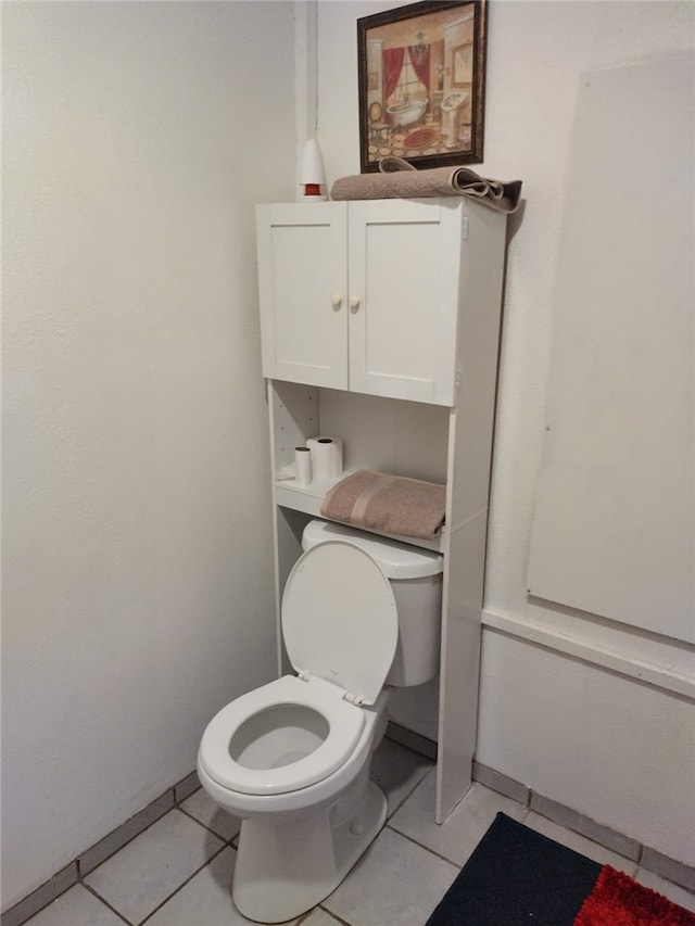 bathroom with toilet and tile patterned floors