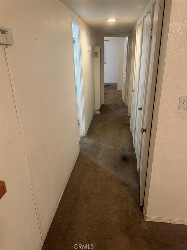 corridor featuring carpet floors and baseboards