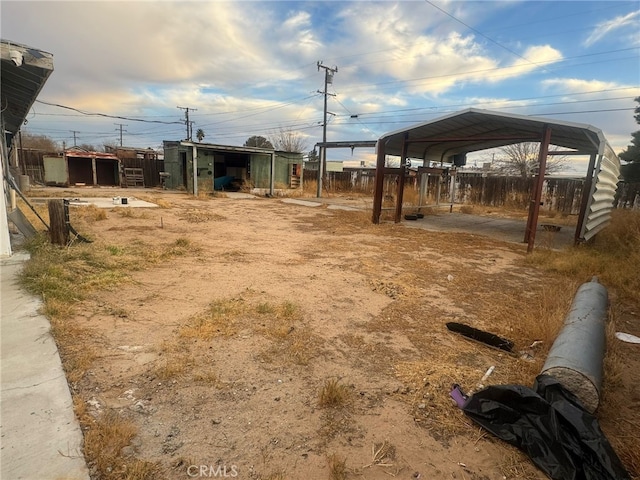 view of yard with fence and a detached carport