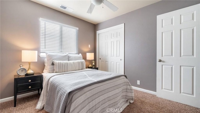 carpeted bedroom featuring ceiling fan and a closet