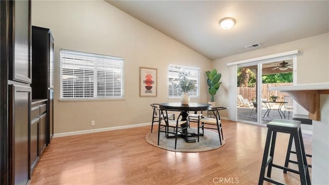 dining area featuring ceiling fan, vaulted ceiling, and light hardwood / wood-style flooring