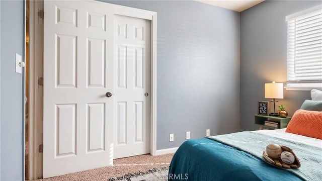 carpeted bedroom with a closet