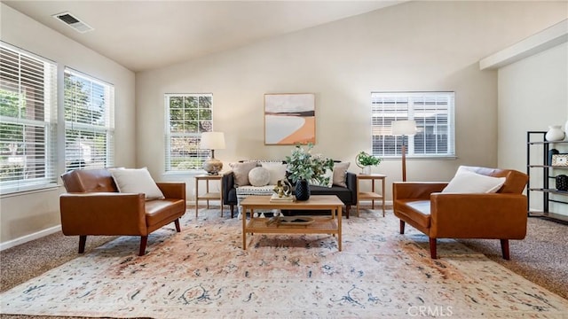 living area featuring light carpet and lofted ceiling