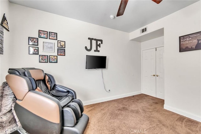 sitting room featuring ceiling fan and carpet floors