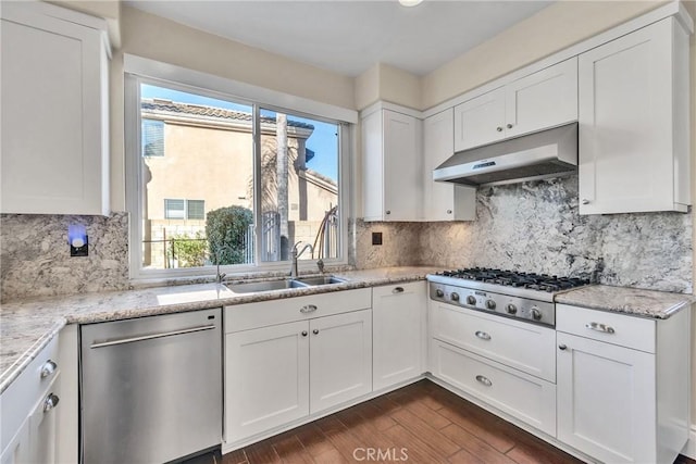 kitchen featuring light stone countertops, appliances with stainless steel finishes, sink, and white cabinets