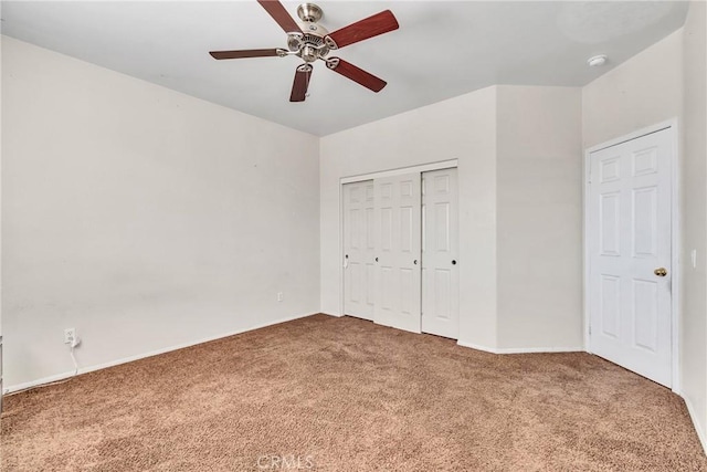 unfurnished bedroom with ceiling fan, a closet, and carpet