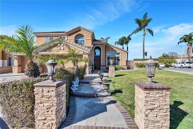 mediterranean / spanish-style house with a front lawn