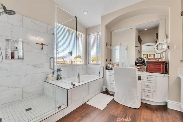 bathroom with hardwood / wood-style flooring, vanity, and separate shower and tub