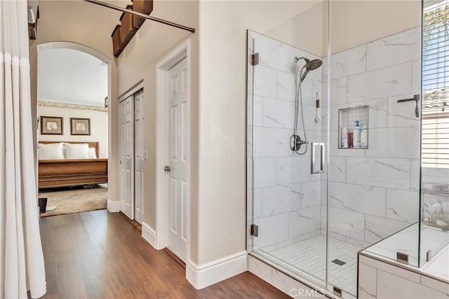 bathroom featuring hardwood / wood-style flooring and walk in shower