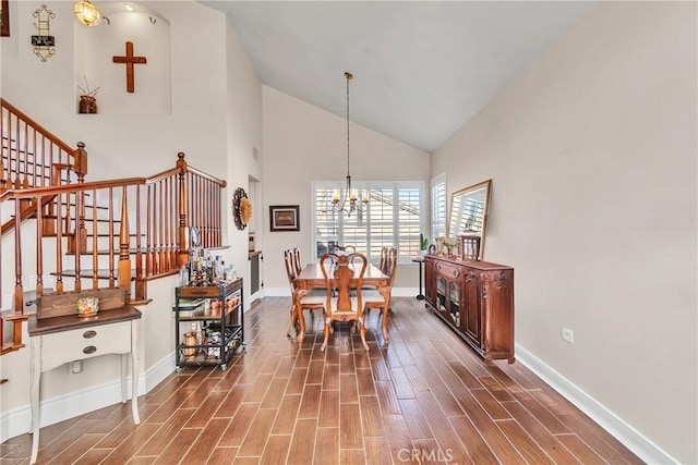 dining room with a chandelier and high vaulted ceiling