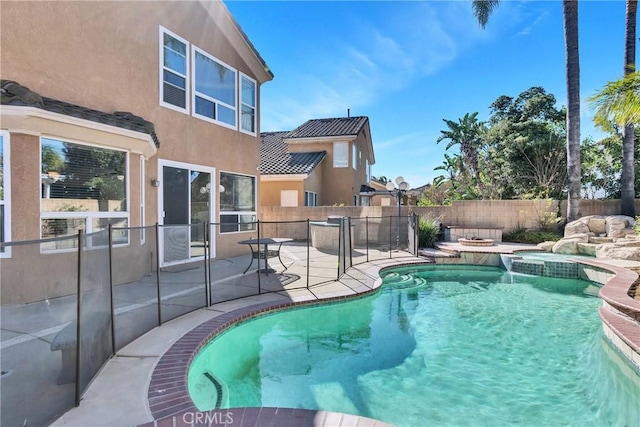 view of pool with an in ground hot tub and a patio