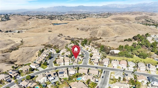 birds eye view of property featuring a mountain view