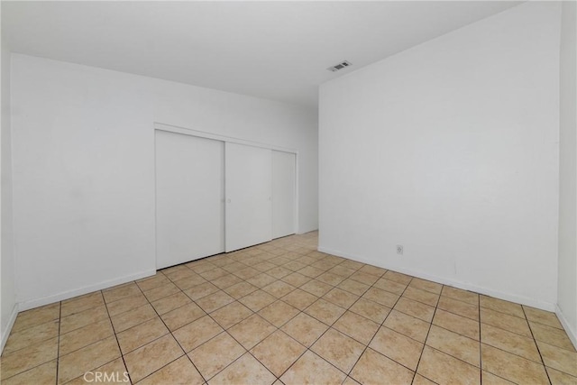 spare room with light tile patterned floors