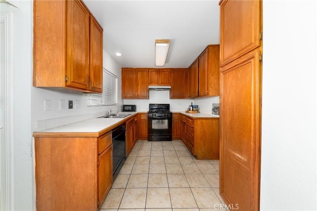 kitchen featuring light tile patterned floors, sink, and black appliances