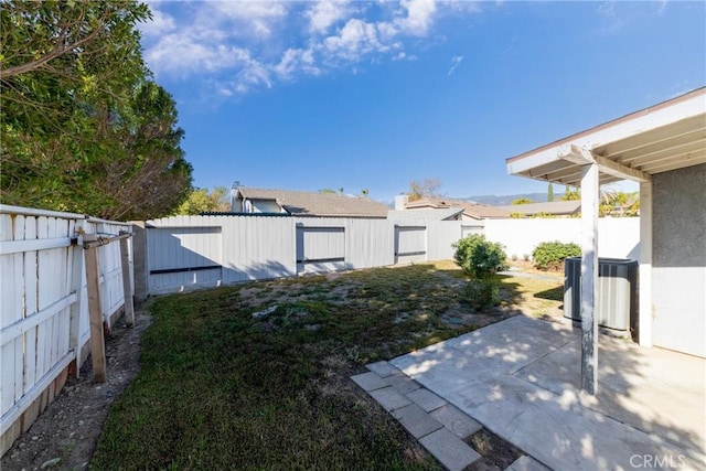 view of yard featuring a patio area and central AC