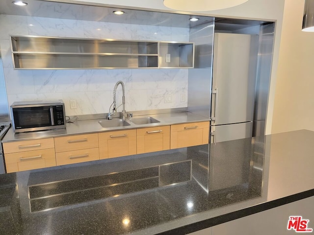 kitchen with tasteful backsplash, sink, and light brown cabinets