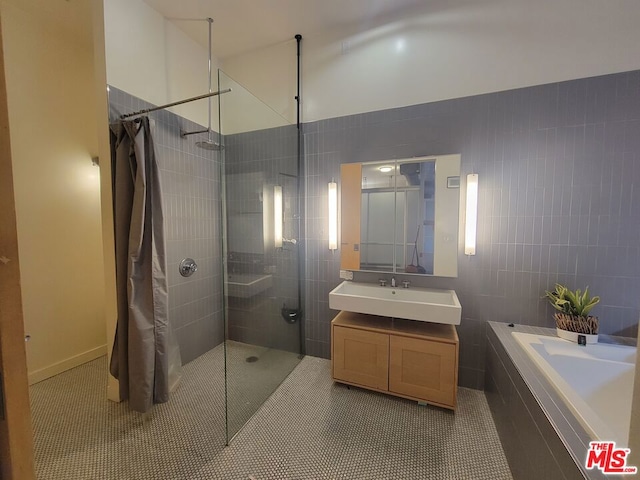 bathroom with vanity, tile patterned floors, and plus walk in shower