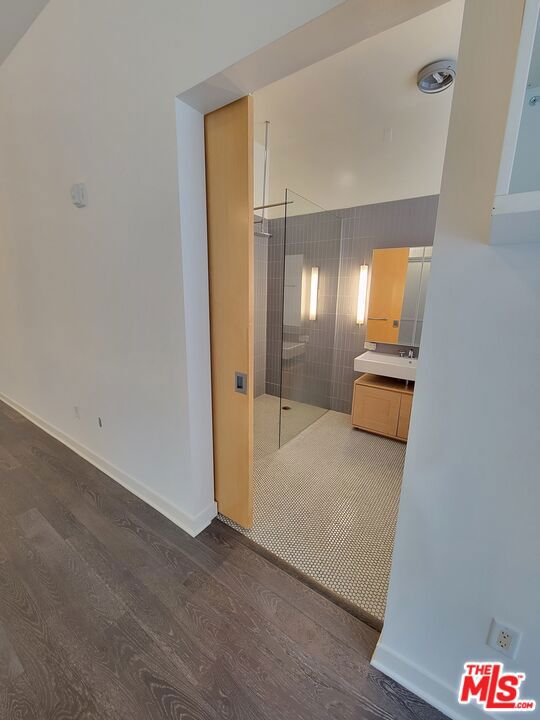 corridor with dark hardwood / wood-style flooring