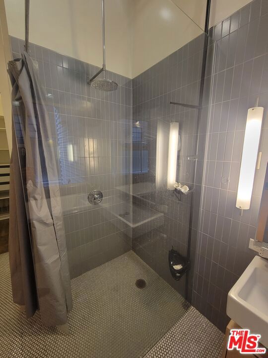 bathroom with tile patterned flooring and a shower with shower curtain