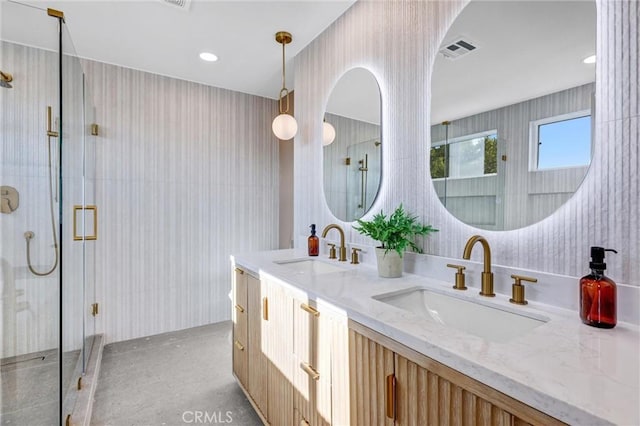 bathroom featuring vanity, concrete flooring, and walk in shower