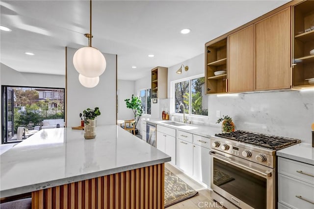 kitchen with light stone countertops, sink, pendant lighting, white cabinets, and appliances with stainless steel finishes