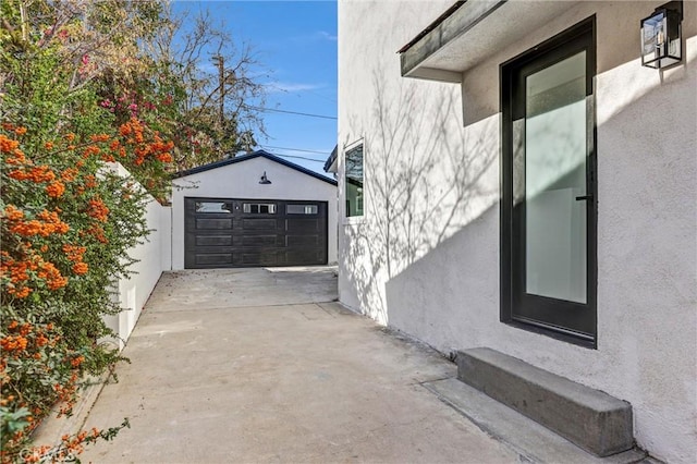 view of side of property featuring a garage and an outbuilding