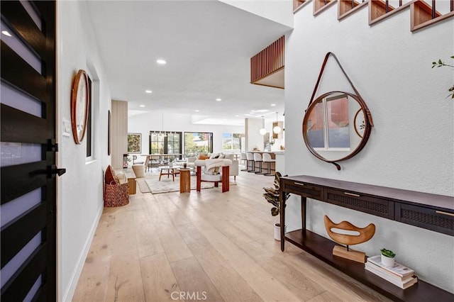 hallway with light hardwood / wood-style flooring