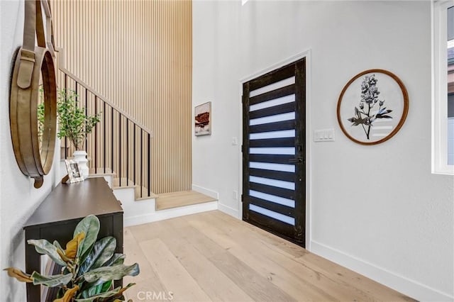 foyer entrance with light hardwood / wood-style floors