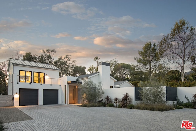 contemporary home with a balcony and a garage