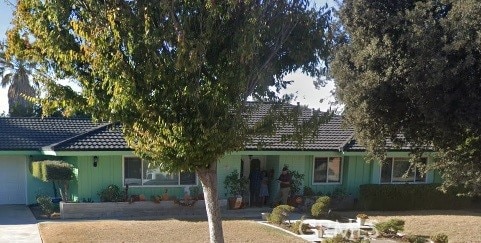 view of front of home featuring a garage, concrete driveway, and a tiled roof