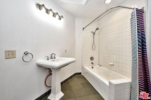 bathroom with tile patterned floors and shower / bath combo with shower curtain