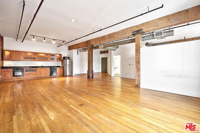 unfurnished living room featuring water heater and light hardwood / wood-style flooring