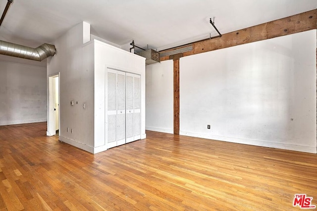 basement with light hardwood / wood-style flooring