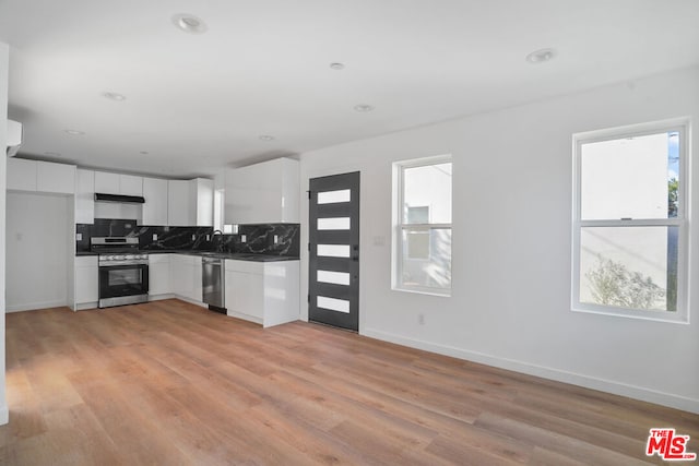 kitchen featuring white cabinetry, plenty of natural light, light wood-type flooring, and appliances with stainless steel finishes