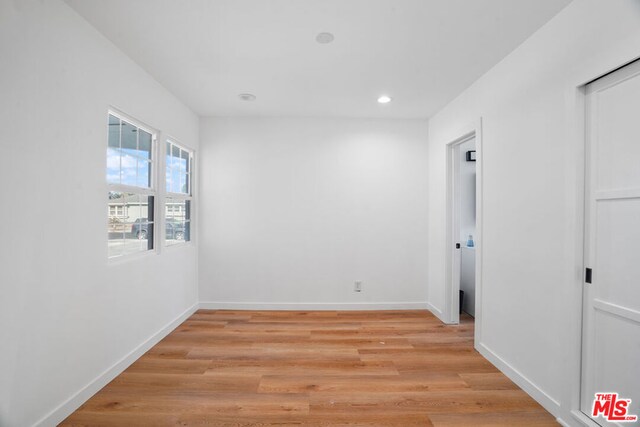 spare room with light hardwood / wood-style flooring