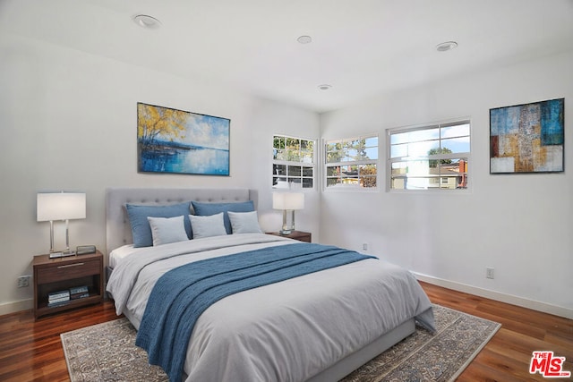 bedroom with dark wood-type flooring