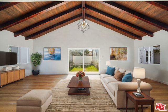 living room with beamed ceiling, an inviting chandelier, light hardwood / wood-style floors, and high vaulted ceiling