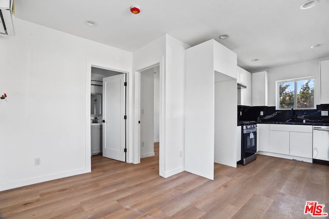 kitchen with white cabinetry, light hardwood / wood-style flooring, stainless steel range oven, backsplash, and white dishwasher