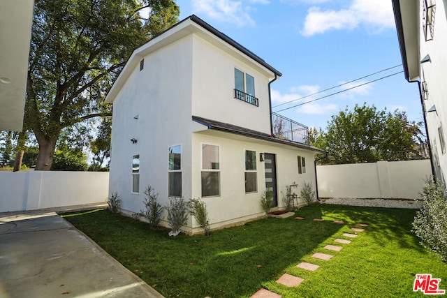 rear view of house with a lawn